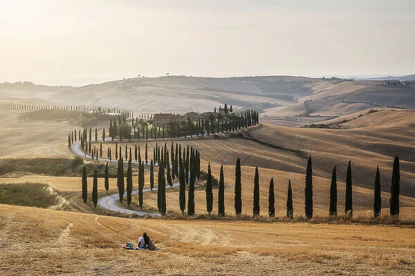 A loving couple found the perfect pic-nic spot: the fields in front of the Agriturismo Baccoleno, in the heart of the Crete Senesi, with all the rolling hills around. Tuscany, Italy