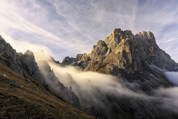 Low clouds and dawn lights on the peaks of Forcella De Furcia