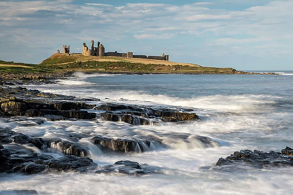 The magnificent ruins of Dunstanburgh Castle on the dramatic Northumbrian coast, Craster, Northumberland, England. Autumn (October) 2021