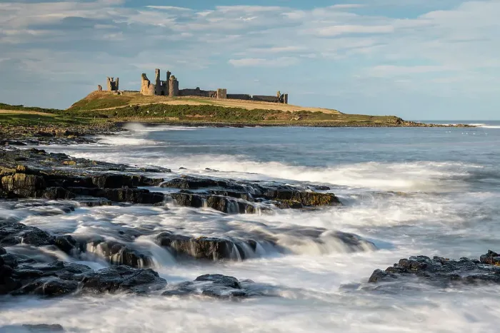 Framed Print : The magnificent ruins of Dunstanburgh Castle on the dramatic Northumbrian coast, Craster, Northumberland, England. Autumn (October) 2021