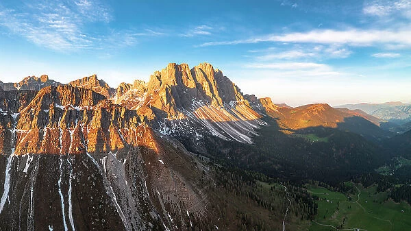 Majestic rocks of the Odle group lit by sunrise, aerial view, Funes Valley, Dolomites, South Tyrol, Italy