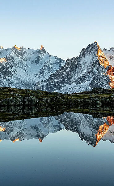 Majestic snowy Mont Blanc Massif and Dent du Geant mirrored in Lacs des Cheserys at sunset, Chamonix, Haute Savoie, France