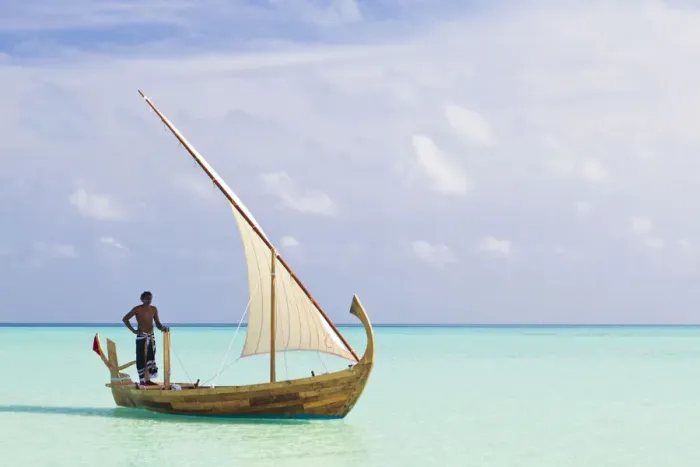 Framed Print : Maldives, Rasdhoo Atoll, Kuramathi Island. A Maldivian man sails a traditional Dhoni. MR Framed Print : Maldives, Rasdhoo Atoll, Kuramathi Island. A Maldivian man sails a traditional Dhoni. MR
