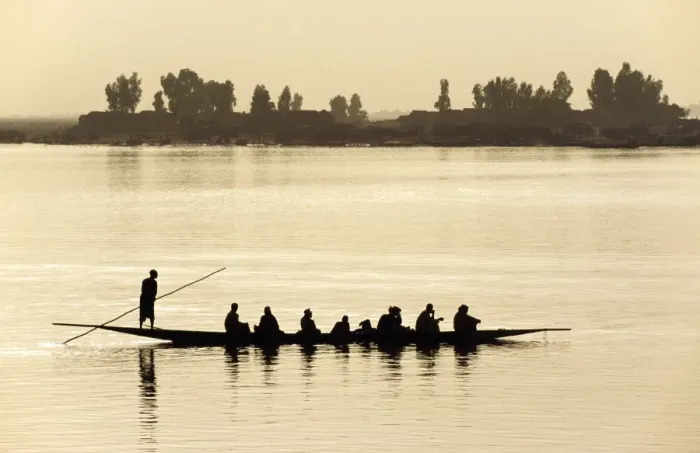 Framed Print : MALI, Mopti A pirogue loaded with passengers is poled Framed Print : MALI, Mopti A pirogue loaded with passengers is poled