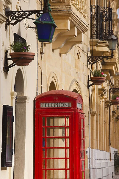 Malta, Gozo Island, Gharb, village square with police station and British telephone box