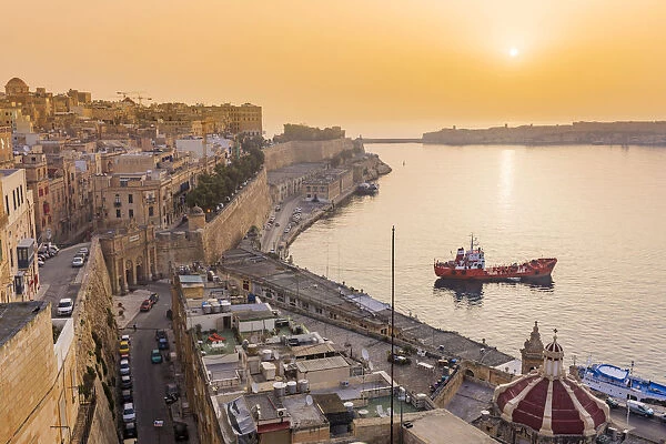 Malta, South Eastern Region, Valletta. The entrance to Grand Harbour at sunrise