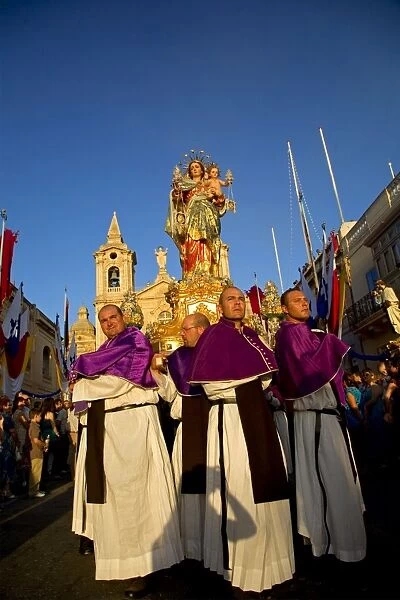 Malta, Zurrieq; Men carrying the statue of the Madonna, the patron saint during the annual parade