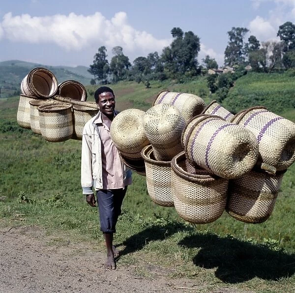 A man carries traditional split-bamboo baskets to sell