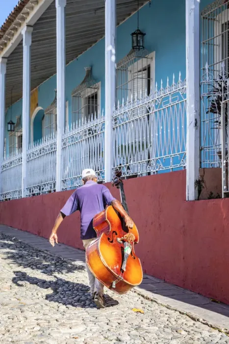 Framed Print : A man carrying a cello in Plaza Mayor in Trinidad, Sancti Spiritus, Cuba Framed Print : A man carrying a cello in Plaza Mayor in Trinidad, Sancti Spiritus, Cuba