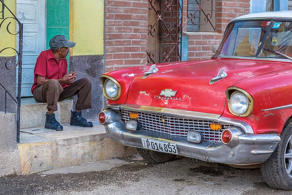 Man and classic American vintage car in Trinidad, Trinidad and Sancti Spiritus Province