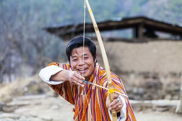 A man doing archery in Paro District, Bhutan