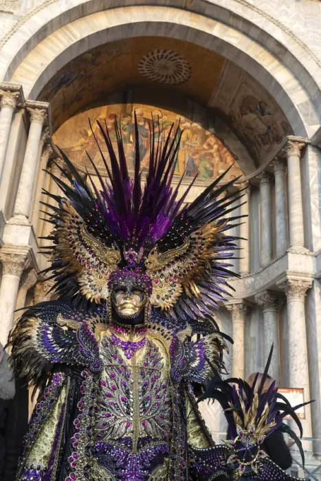 Framed Print : A man in an elaborate costume stands in front of the Basilica Saan Marco in St