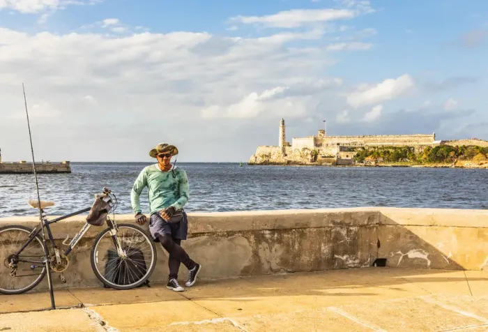 Framed Print : A man with fishing equipment on the Malacon with Castillo De Los Tres Reyes Del Morro Framed Print : A man with fishing equipment on the Malacon with Castillo De Los Tres Reyes Del Morro