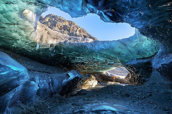 Man in an ice cave of Breidamerkurjokull, Austurland, Iceland