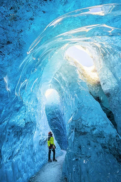 Man in an ice cave of Breidamerkurjokull, Austurland, Iceland(MR)