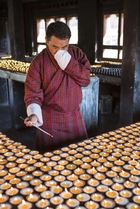 Framed Print : A man lighting candles in a shrine in Jambey Lhakhang, Jakar, Bumthang District, Bhutan Framed Print : A man lighting candles in a shrine in Jambey Lhakhang, Jakar, Bumthang District, Bhutan