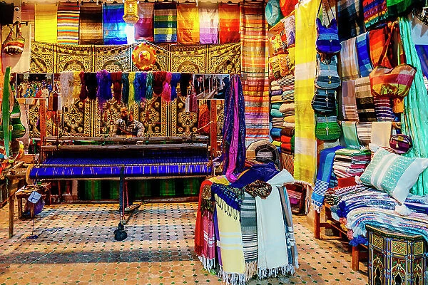 Man at the loom, colorful fabrics. Fez, Morocco