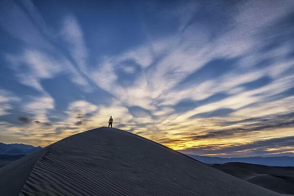 Man on Mesquite Dunes at Sunrise, Death Valley National Park, California, USA