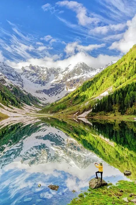 Framed Print : Man photographing mountains reflected in lake with smartphone standing on rocks, Valtellina, Lombardy, Italy Framed Print : Man photographing mountains reflected in lake with smartphone standing on rocks, Valtellina, Lombardy, Italy