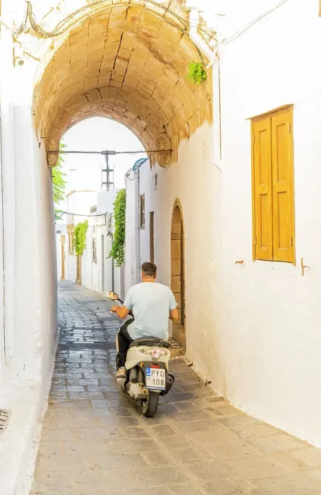 Framed Print : A man on a scooter in Lindos, Rhodes, Dodecanese Islands, Greece Framed Print : A man on a scooter in Lindos, Rhodes, Dodecanese Islands, Greece