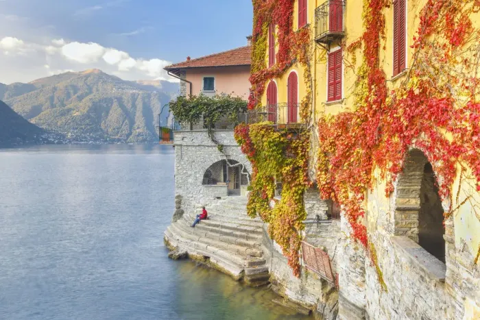 Framed Print : A man sitting on the steps of Nesso village admire the lake of Como, Como province Framed Print : A man sitting on the steps of Nesso village admire the lake of Como, Como province