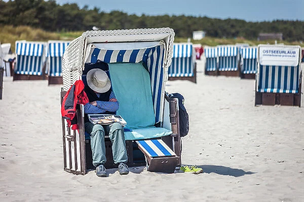 Man sleeping in a beach chair on the beach at Zingst, Mecklenburg-Western Pomerania, Baltic Sea, Northern Germany, Germany