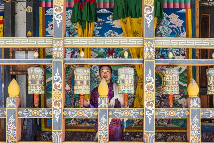 Framed Print : A man spinning prayer wheels in Trongsa Dzong, Trongsa District, Bhutan