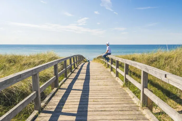 Framed Print : Man standing on a footbridge to Weissenhaauser Strand, Ostholstein, Schleswig-Holstein Framed Print : Man standing on a footbridge to Weissenhaauser Strand, Ostholstein, Schleswig-Holstein