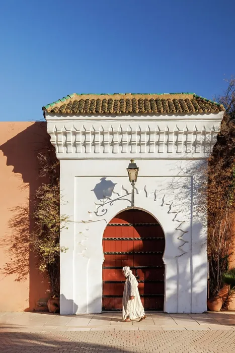 Framed Print : Man in traditional dress walking in front of door at Koutoubia Mosque, Marrakech, Morocco Framed Print : Man in traditional dress walking in front of door at Koutoubia Mosque, Marrakech, Morocco