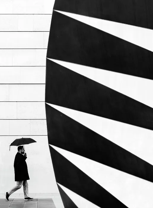 Framed Print : Man with umbrella walking past the Angel's Wings air vent in Paternoster Square, London, England Framed Print : Man with umbrella walking past the Angel's Wings air vent in Paternoster Square, London, England