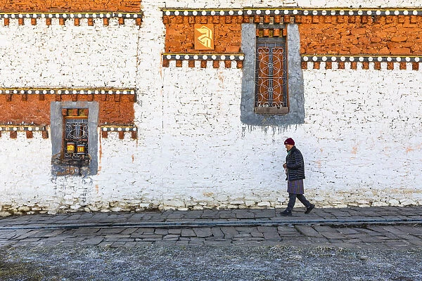 A man walking around Jambey Lhakhang, Jakar, Bumthang District, Bhutan