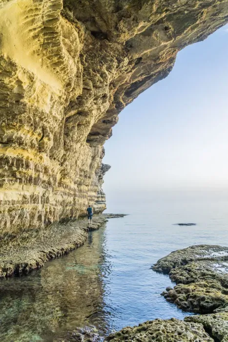 Framed Print : A man walking at the sea caves at Cape Greco, Famagusta District, Cyprus Framed Print : A man walking at the sea caves at Cape Greco, Famagusta District, Cyprus