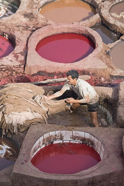 Man working in vats of coloured dye in the tanneries, Fez, Morocco
