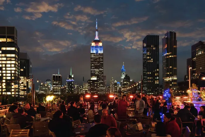 Framed Print : Manhattan rooftop, people having fun wit skyline on background at night, New York City, USA Framed Print : Manhattan rooftop, people having fun wit skyline on background at night, New York City, USA