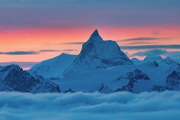 Matterhorn peak over a clouy carpet during a winter sunrise