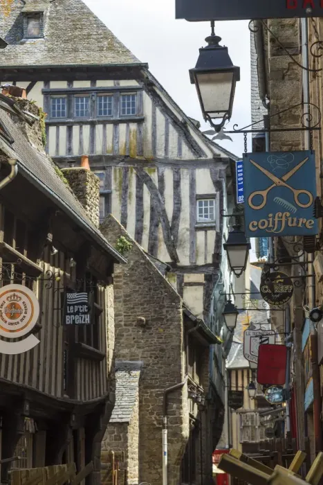 Framed Print : Medieval half-timbered houses and shop signs, Dinan, Brittany, France Framed Print : Medieval half-timbered houses and shop signs, Dinan, Brittany, France