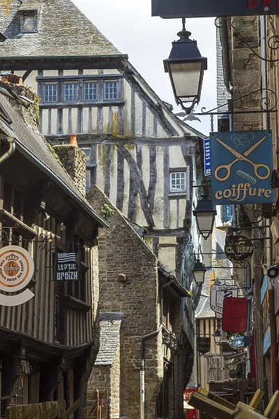 Medieval half-timbered houses and shop signs, Dinan, Brittany, France