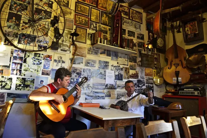 Framed Print : Men play musical instruments at a bar in Crete, Greece, Europe Framed Print : Men play musical instruments at a bar in Crete, Greece, Europe