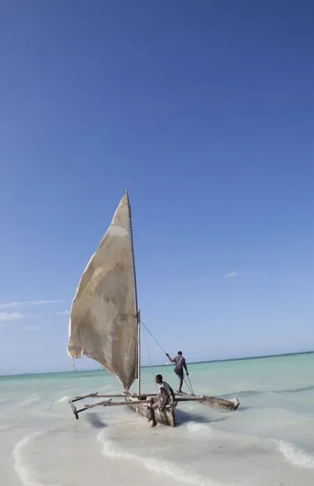 Framed Print : Two men sailing a boat in the surf off Zanzibar in East Africa Framed Print : Two men sailing a boat in the surf off Zanzibar in East Africa