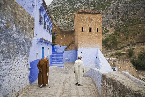 Two Men walking on the edge of the medina in Chefchaouen, Morocco