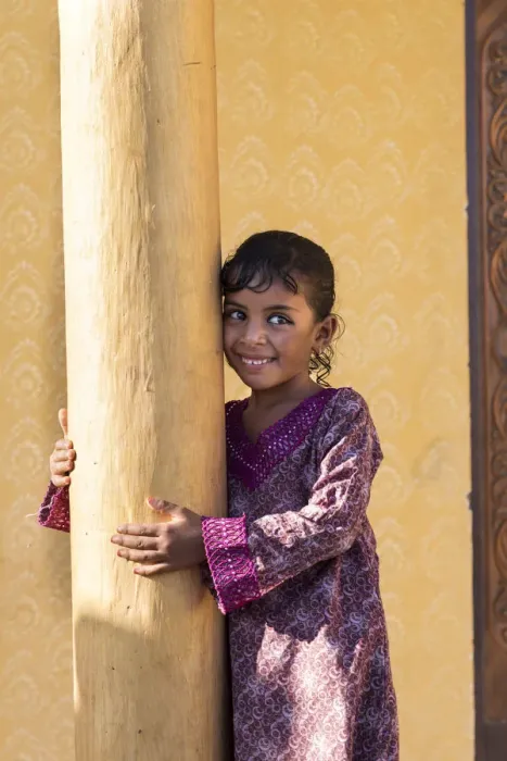 Framed Print : Middle East, Oman, Wahiba sands, a smiley bedouin girl wearing a pretty dress Framed Print : Middle East, Oman, Wahiba sands, a smiley bedouin girl wearing a pretty dress