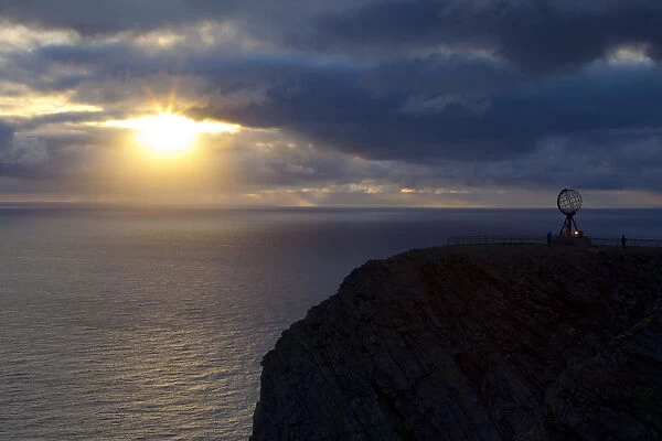 The Midnight Sun breaks through the clouds at Nordkapp, Finnmark, Norway