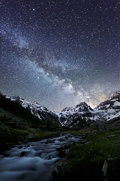 Milky way on a mountain, with a little river in the middle of the valley, Marittime Alps