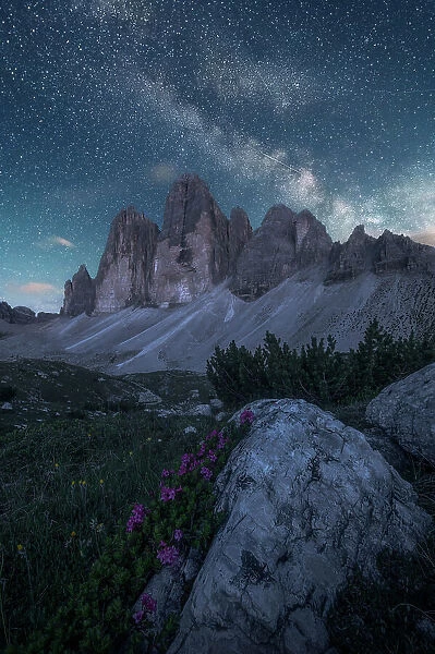 The milky way rising above the Tre Cime di Lavaredo on a clear summer night. Dolomites, Italy