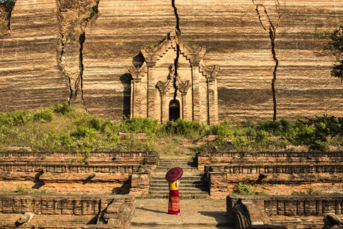 Framed Print : Mingun, Sagaing region, Myanmar (Burma). Woman with red umbrella looks at the Pahtodawgyi
