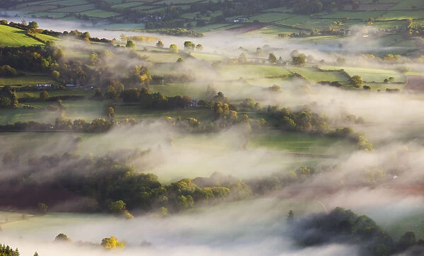 Mist blows over rolling countryside in the early morning near Talybont-on-Usk, Brecon