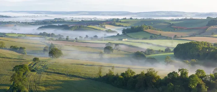 Framed Print : Mist shrouded rolling countryside near Berry Pomeroy in the South Hams of Devon, England. Autumn (September) 2023