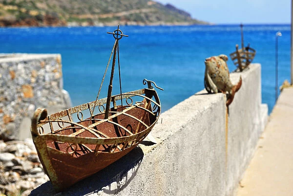 Model of a rusted ship is placed as an ornament on a wall in Plaka, Crete, Greece, Europe
