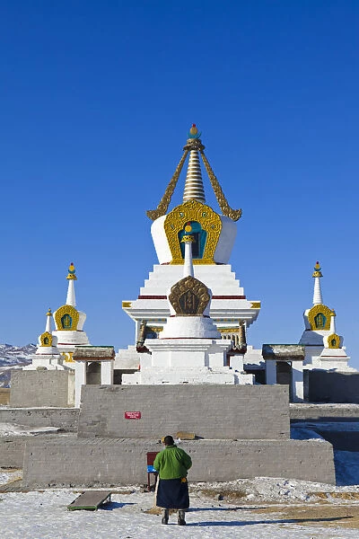 Mongolia, Ovorkhangai, Kharkhorin. Erdene Zuu Monastery. A man prays at a stupa