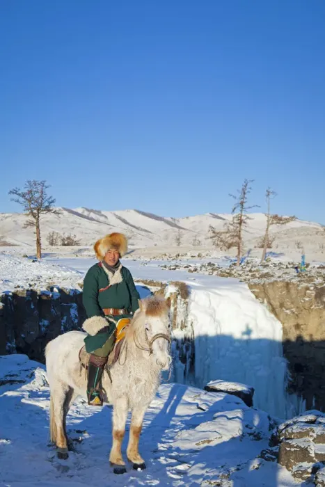 Framed Print : Mongolia, Ovorkhangai, Orkkhon Valley. A man sits on horseback by a frozen waterfall